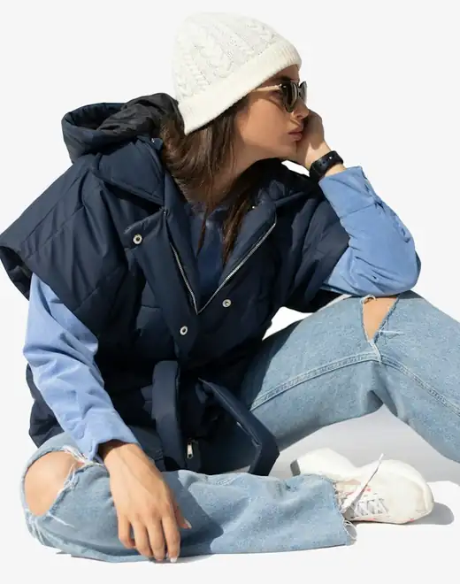 Model wearing a navy puffer gilet
